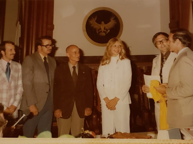 Molly (Van Benthuysen) Bolin became the first woman to sign a contract with a U.S. women's professional basketball league. At the far right is then-Gov. Bob Ray.