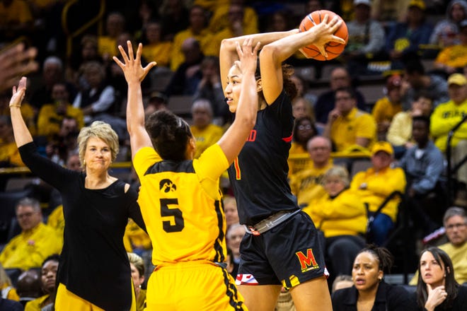 Maryland forward Shakira Austin (1) looks to pass as Iowa guard Alexis Sevillian (5) defends during a NCAA college Big Ten Conference women's basketball game, Thursday, Jan. 9, 2020, at Carver-Hawkeye Arena in Iowa City, Iowa.