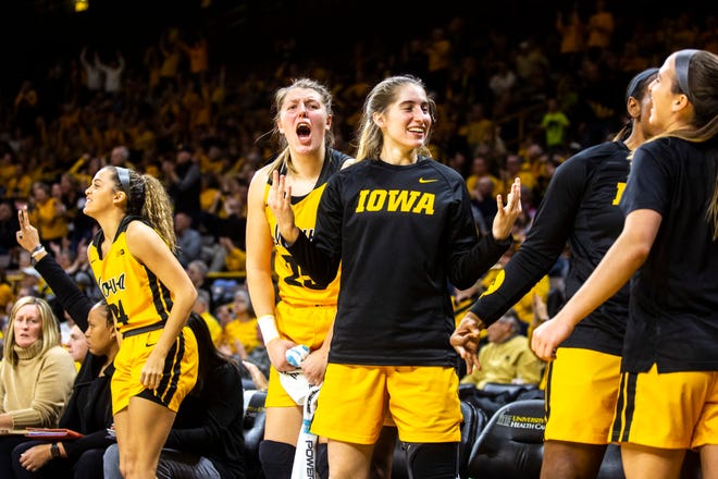 Iowa players, from left, Gabbie Marshall, Monika Czinano and Kate Martin celebrate a 3-point basket during a NCAA college Big Ten Conference women's basketball game, Thursday, Jan. 9, 2020, at Carver-Hawkeye Arena in Iowa City, Iowa.