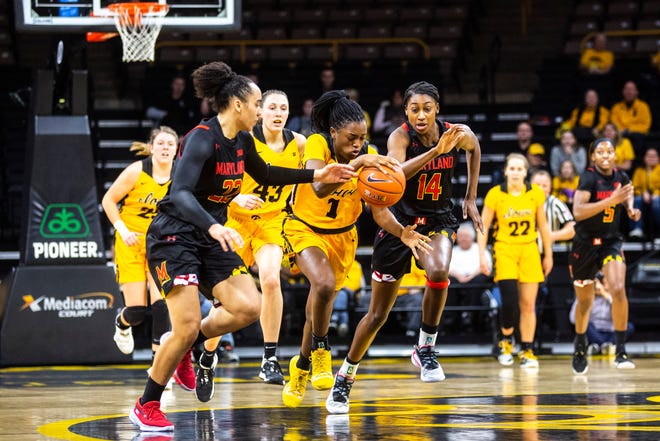 Iowa guard Tomi Taiwo (1) battles Maryland guard Blair Watson (22) for a loose ball during a NCAA college Big Ten Conference women's basketball game, Thursday, Jan. 9, 2020, at Carver-Hawkeye Arena in Iowa City, Iowa.