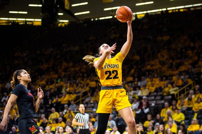 Iowa guard Kathleen Doyle (22) makes a basket as Maryland forward Shakira Austin (1) defends during a NCAA college Big Ten Conference women's basketball game, Thursday, Jan. 9, 2020, at Carver-Hawkeye Arena in Iowa City, Iowa.