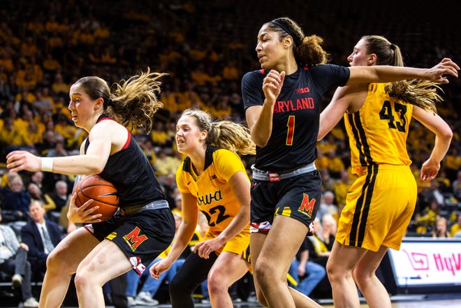 Maryland guard Taylor Mikesell (11) pulls down a rebound against Iowa guard Kathleen Doyle (22) as Maryland forward Shakira Austin (1) and Iowa forward Amanda Ollinger (43) defend during a NCAA college Big Ten Conference women's basketball game, Thursday, Jan. 9, 2020, at Carver-Hawkeye Arena in Iowa City, Iowa.