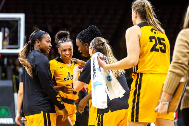 Iowa guard Alexis Sevillian (5) is embraced by teammates heading into a timeout during a NCAA college Big Ten Conference women's basketball game, Thursday, Jan. 9, 2020, at Carver-Hawkeye Arena in Iowa City, Iowa.