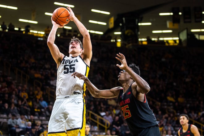 Iowa center Luka Garza (55) makes a basket as Maryland forward Jalen Smith (25) defends during a NCAA college Big Ten Conference men's basketball game, Friday, Jan. 10, 2020, at Carver-Hawkeye Arena in Iowa City, Iowa.