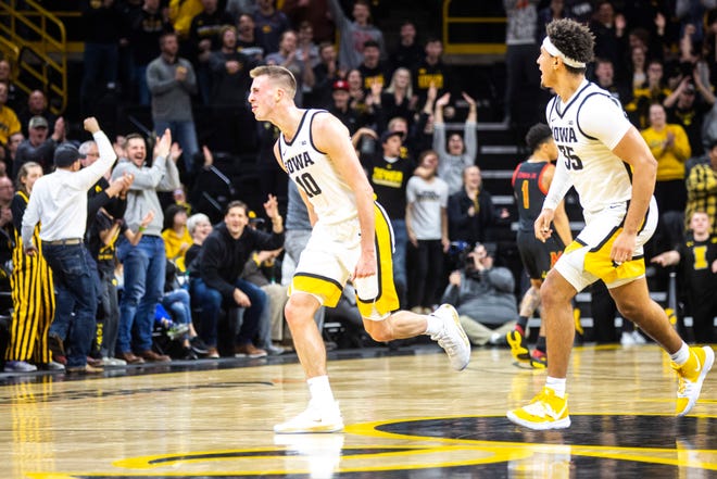 Iowa guard Joe Wieskamp (10) runs up court while celebrating with teammate Cordell Pemsl, right, after making a 3-point basket during a NCAA college Big Ten Conference men's basketball game, Friday, Jan. 10, 2020, at Carver-Hawkeye Arena in Iowa City, Iowa.