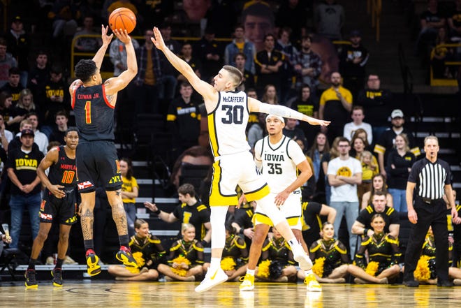 Iowa guard Connor McCaffery (30) defends a 3-point basket attempt from Maryland guard Anthony Cowan Jr. (1) during a NCAA college Big Ten Conference men's basketball game, Friday, Jan. 10, 2020, at Carver-Hawkeye Arena in Iowa City, Iowa.