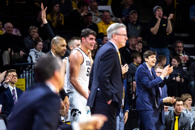 Iowa forward Patrick McCaffery, far right, cheers from the bench with teammates during a NCAA college Big Ten Conference men's basketball game, Friday, Jan. 10, 2020, at Carver-Hawkeye Arena in Iowa City, Iowa.