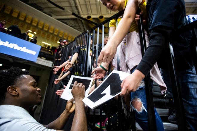 Iowa guard Joe Toussaint (1) signs autographs for fans after a NCAA college Big Ten Conference men's basketball game against Maryland, Friday, Jan. 10, 2020, at Carver-Hawkeye Arena in Iowa City, Iowa.