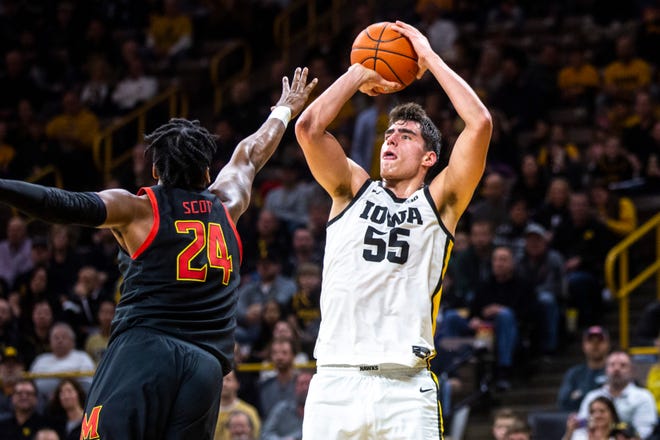 Iowa center Luka Garza (55) shoots a 2-point basket as Maryland forward Donta Scott (24) defends during a NCAA college Big Ten Conference men's basketball game, Friday, Jan. 10, 2020, at Carver-Hawkeye Arena in Iowa City, Iowa.