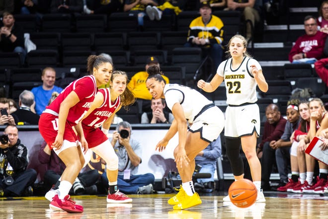 Iowa guard Alexis Sevillian (5) misses a pass from Iowa guard Kathleen Doyle (22) as Indiana's Jaelynn Penn, left, and Ali Patberg defend during a NCAA Big Ten Conference women's basketball game, Sunday, Jan. 12, 2020, at Carver-Hawkeye Arena in Iowa City, Iowa.
