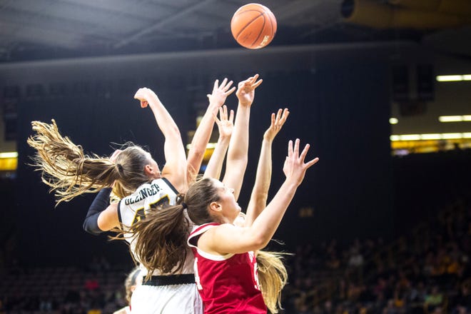 Iowa forward Amanda Ollinger, far left, and Indiana's Mackenzie Holmes, foreground, battle for a rebound off of a free throw against other players during a NCAA Big Ten Conference women's basketball game, Sunday, Jan. 12, 2020, at Carver-Hawkeye Arena in Iowa City, Iowa.