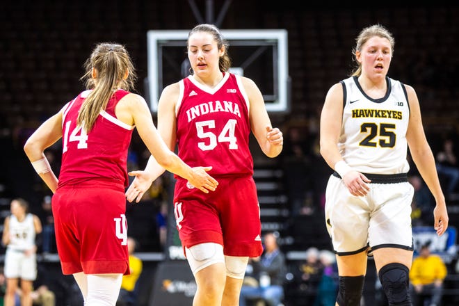 Iowa center Monika Czinano (25) walks up court after a turnover as Indiana's Ali Patberg (14) gives teammate Mackenzie Holmes (54) a high-five during a NCAA Big Ten Conference women's basketball game, Sunday, Jan. 12, 2020, at Carver-Hawkeye Arena in Iowa City, Iowa.