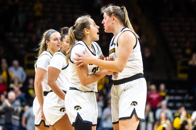 Iowa guard Kathleen Doyle (22) huddle up with teammate Monika Czinano, right, during a NCAA Big Ten Conference women's basketball game, Sunday, Jan. 12, 2020, at Carver-Hawkeye Arena in Iowa City, Iowa.