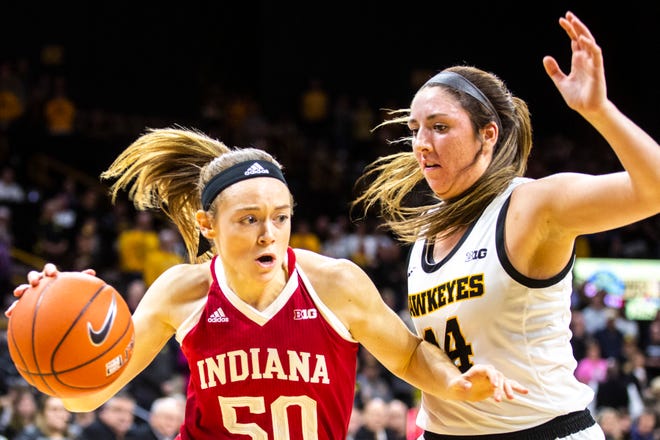 Indiana forward Brenna Wise (50) drives to the basket as Iowa's McKenna Warnock (14) defends during a NCAA Big Ten Conference women's basketball game, Sunday, Jan. 12, 2020, at Carver-Hawkeye Arena in Iowa City, Iowa.