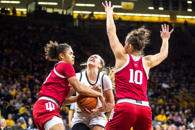Indiana guard Jaelynn Penn, left, gets a steal from Iowa guard Kathleen Doyle, center, while she drives to the basket as Indiana forward  Aleksa Gulbe (10) defends during a NCAA Big Ten Conference women's basketball game, Sunday, Jan. 12, 2020, at Carver-Hawkeye Arena in Iowa City, Iowa.