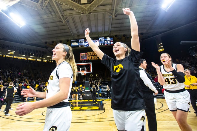 Iowa players Makenzie Meyer, left, Megan Meyer and Amanda Ollinger (43) celebrate after defeating Indiana during a NCAA Big Ten Conference women's basketball game, Sunday, Jan. 12, 2020, at Carver-Hawkeye Arena in Iowa City, Iowa.