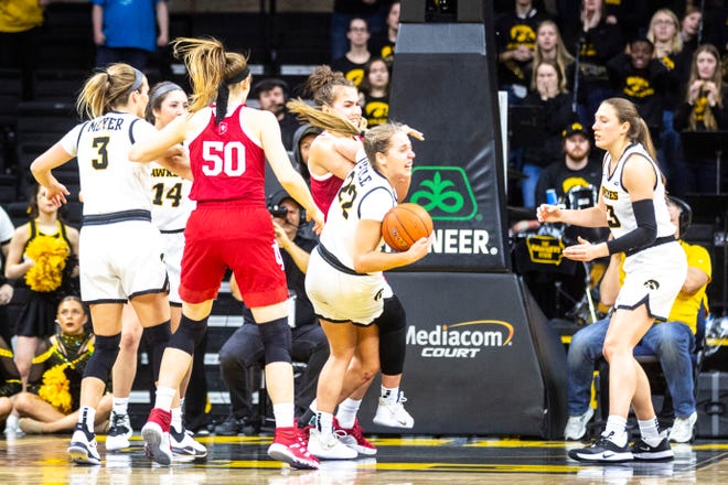 Iowa guard Kathleen Doyle (22) battles for a rebound against Indiana guard Grace Berger during a NCAA Big Ten Conference women's basketball game, Sunday, Jan. 12, 2020, at Carver-Hawkeye Arena in Iowa City, Iowa.