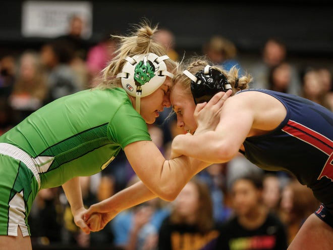 Osage's Emma Grimm, left, locks up with Davenport Central's Sydney Park in their match at 126 pounds on Saturday, Jan. 25, 2020, at Waverly-Shell Rock High School.