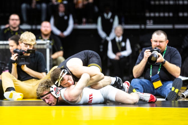 Iowa's Spencer Lee, top, wrestles Ohio State's Hunter Lucas at 125 pounds during a NCAA Big Ten Conference wrestling dual, Friday, Jan. 24, 2020, at Carver-Hawkeye Arena in Iowa City, Iowa.