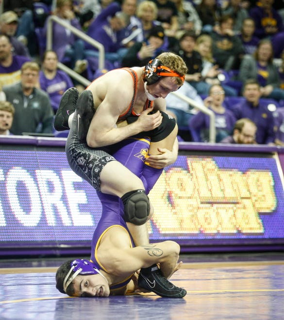 Northern Iowa's Michael Blockhus holds the legs of Oklahoma State's Dusty Hone at 141 pounds on Saturday, Jan. 25, 2020, at the McCleod Center in Cedar Falls.