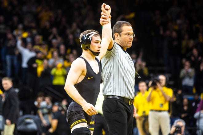 Iowa's Spencer Lee has his hand raised after winning a match at 125 pounds during a NCAA Big Ten Conference wrestling dual against Penn State, Friday, Jan. 31, 2020, at Carver-Hawkeye Arena in Iowa City, Iowa.