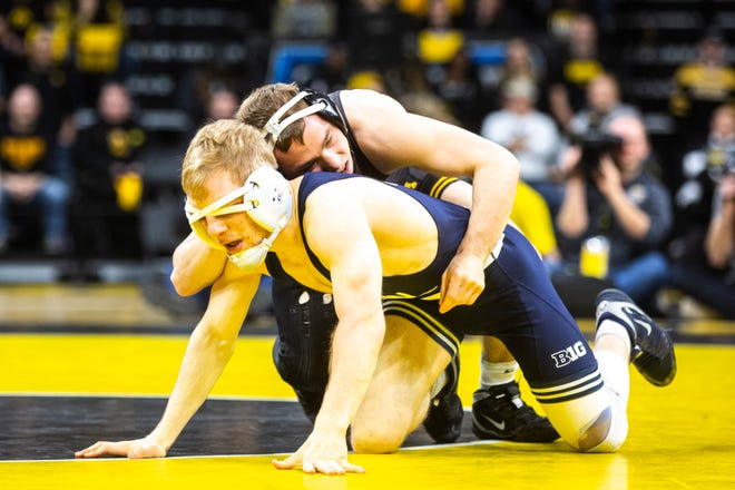 Iowa's Spencer Lee, right, wrestles Penn State's Brandon Meredith at 125 pounds during a NCAA Big Ten Conference wrestling dual, Friday, Jan. 31, 2020, at Carver-Hawkeye Arena in Iowa City, Iowa.