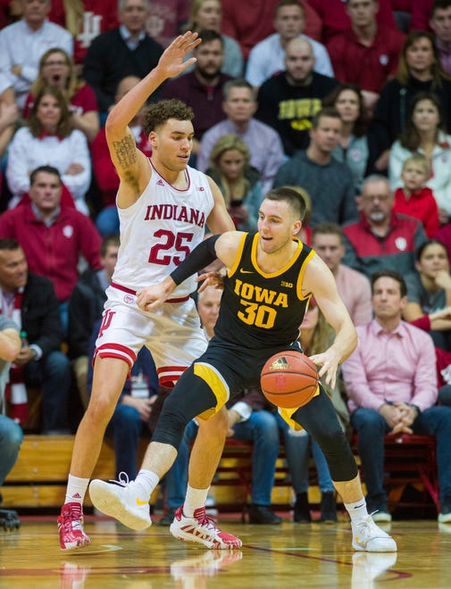 Indiana forward Race Thompson (25) defends against Iowa guard Connor McCaffery (30) who works the ball toward the basket during the first half of an NCAA college basketball game, Thursday, Feb. 13, 2020, in Bloomington, Ind. (AP Photo/Doug McSchooler)