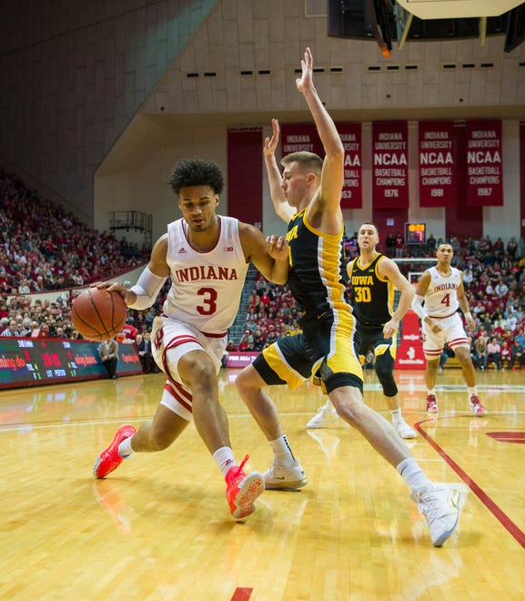 Indiana forward Justin Smith (3) is stopped along the baseline en route to the basket by Iowa guard Joe Wieskamp (10) during the first half of an NCAA college basketball game, Thursday, Feb. 13, 2020, in Bloomington, Ind. (AP Photo/Doug McSchooler)