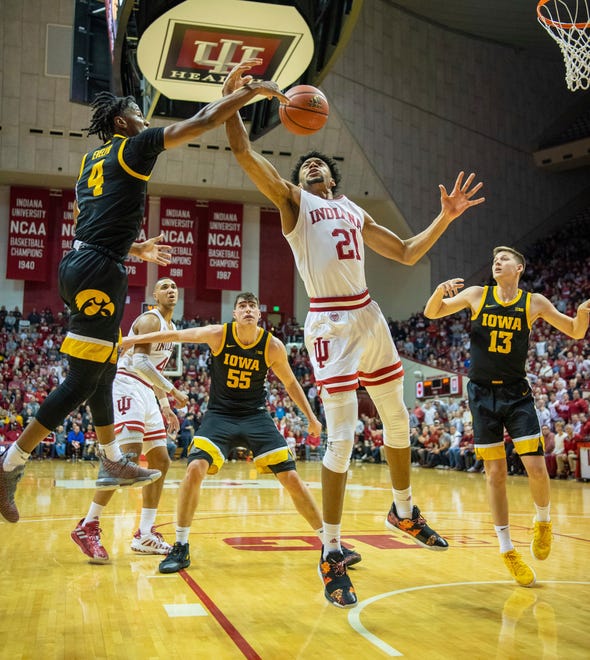 Iowa guard Bakari Evelyn (4), left, swats the ball away from Indiana forward Jerome Hunter (21) who drives to the basket during the first half of an NCAA college basketball game, Thursday, Feb. 13, 2020, in Bloomington, Ind. (AP Photo/Doug McSchooler)