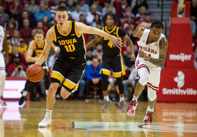 Iowa guard Joe Wieskamp (10) races upcourt with the ball after a steal from Indiana guard Devonte Green (11) during the second half of an NCAA college basketball game, Thursday, Feb. 13, 2020, in Bloomington, Ind. (AP Photo/Doug McSchooler)