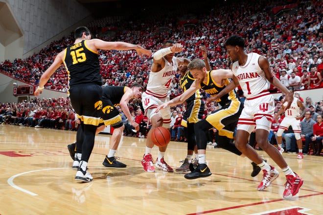 Feb. 13, 2020; Bloomington, Indiana, USA; Indiana Hoosiers guard Aljami Durham (1) scrambles for a loose ball against Iowa Hawkeyes forward Riley Till (20) during the first half at Simon Skjodt Assembly Hall.