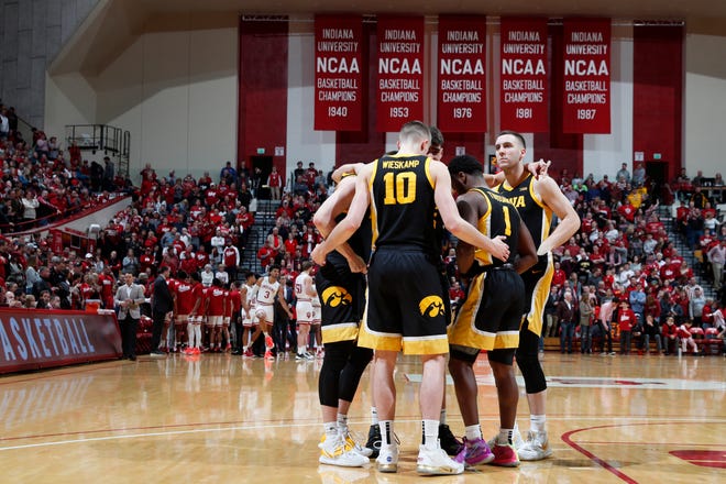 Feb. 13, 2020; Bloomington, Indiana, USA; Iowa Hawkeyes huddle up on the floor before the game against the Indiana Hoosiers at Simon Skjodt Assembly Hall.