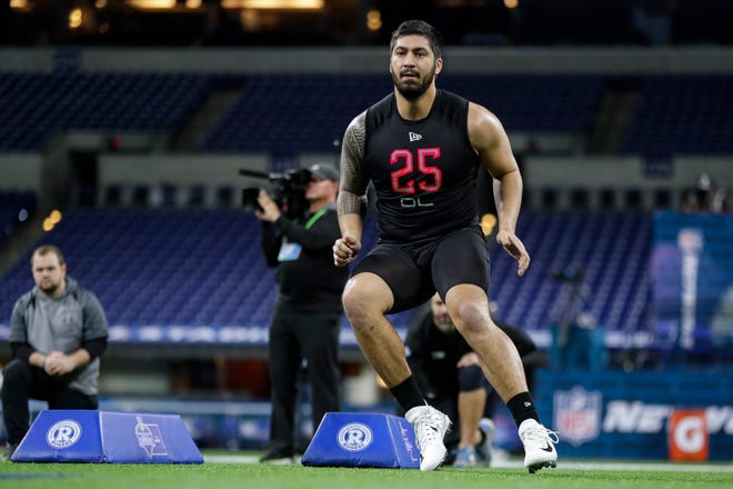 Iowa defensive lineman A.J. Epenesa runs a drill at the NFL football scouting combine in Indianapolis, Saturday, Feb. 29, 2020.