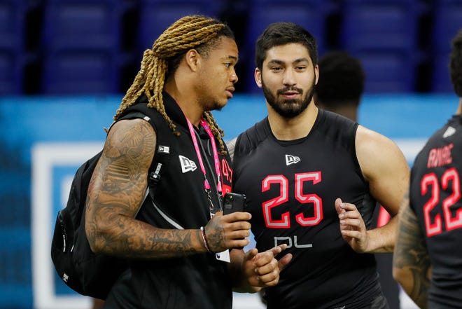 Ohio State defensive lineman Chase Young, left, talks with Iowa defensive lineman A.J. Epenesa at the NFL football scouting combine in Indianapolis, Saturday, Feb. 29, 2020.