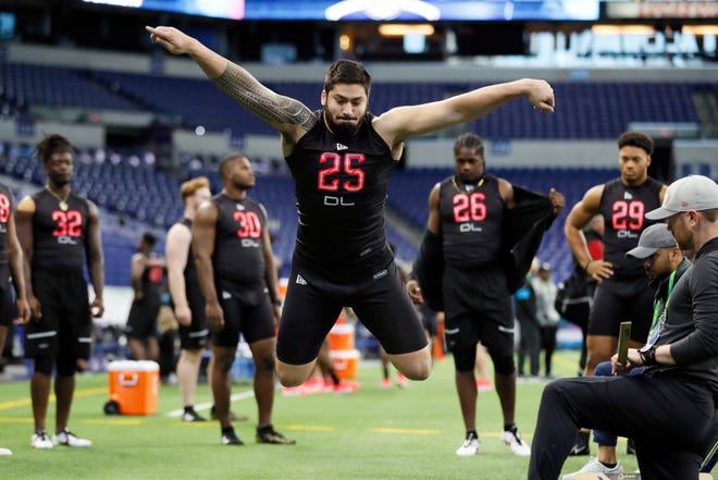 Iowa defensive lineman A.J. Epenesa participates in a drill at the NFL football scouting combine in Indianapolis, Saturday, Feb. 29, 2020.