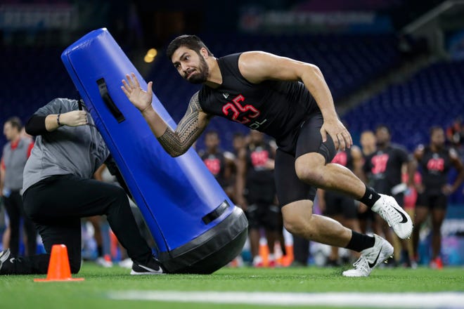 Iowa defensive lineman A.J. Epenesa runs a drill at the NFL football scouting combine in Indianapolis, Saturday, Feb. 29, 2020.