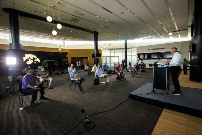 Reporters sit apart from one another while practicing social distancing as Iowa athletic director Gary Barta speaks during a news conference, Monday, June 15, 2020, at Carver-Hawkeye Arena in Iowa City, Iowa.