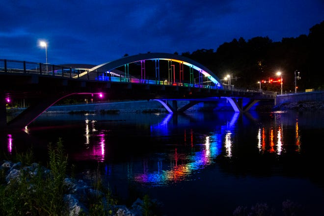 Park Road Bridge is illuminated in a rainbow of colors during Pride month, Tuesday, June 30, 2020, over the Iowa River in Iowa City, Iowa.