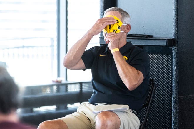 Iowa head coach Kirk Ferentz adjusts his face mask after speaking during a news conference, Thursday, July 16, 2020, at the Pacha Family Club Room in the north end zone of Kinnick Stadium in Iowa City, Iowa.