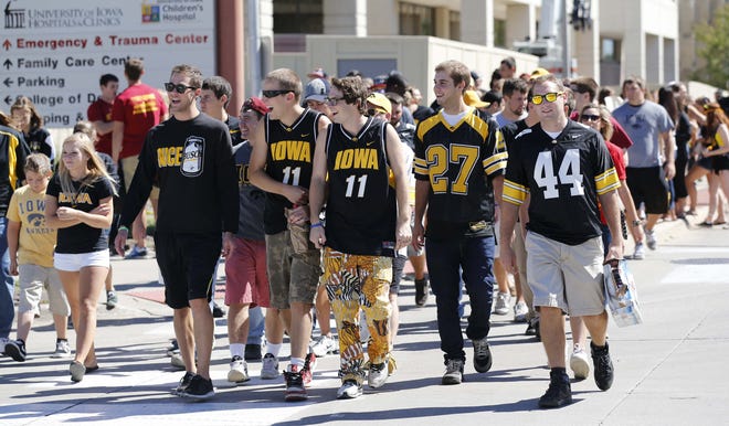 Fans walk along Melrose Ave. while tailgating before the Iowa vs Iowa State football game Saturday Sept. 8, 2012, at Kinnick Stadium in Iowa City, Iowa.