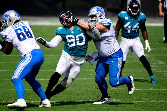 Detroit Lions guard Joe Dahl is called for a penalty against Jacksonville Jaguars defensive tackle Taven Bryan during the first half at TIAA Bank Field, Oct. 18, 2020.