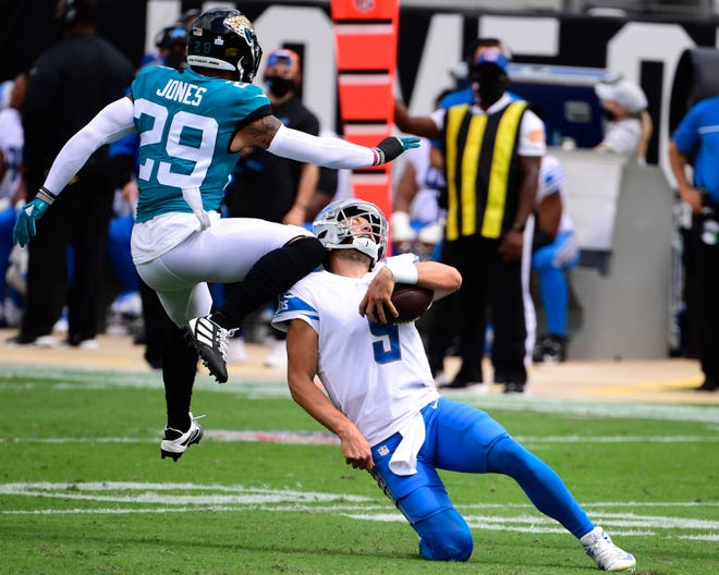 Detroit Lions quarterback Matthew Stafford scrambles with the ball against Jacksonville Jaguars safety Josh Jones during the first half at TIAA Bank Field, Oct. 18, 2020.