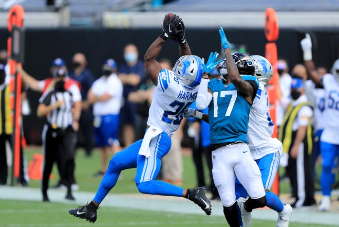 Duron Harmon (26) of the Detroit Lions intercepts the ball intended for D.J. Chark (17) of the Jacksonville Jaguars during the second quarter in the game at TIAA Bank Field on Oct. 18, 2020, in Jacksonville, Florida.