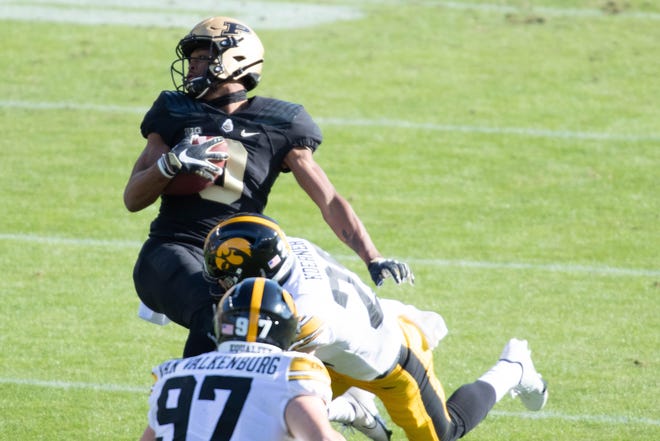 Oct 24, 2020; West Lafayette, Indiana, USA; Purdue Boilermakers wide receiver Milton Wright (0) catches the ball and is tackled by Iowa Hawkeyes defensive back Sebastian Castro (29)in the first quarter at Ross-Ade Stadium. Mandatory Credit: Trevor Ruszkowski-USA TODAY Sports