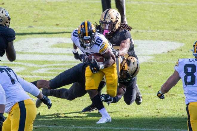 Oct 24, 2020; West Lafayette, Indiana, USA; Iowa Hawkeyes running back Mekhi Sargent (10) runs the ball while Purdue Boilermakers try and tackle him in the first quarter at Ross-Ade Stadium. Mandatory Credit: Trevor Ruszkowski-USA TODAY Sports