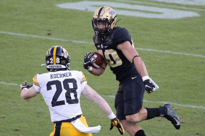 Oct 24, 2020; West Lafayette, Indiana, USA; Purdue Boilermakers running back Zander Horvath (40) runs the ball while Iowa Hawkeyes defensive back Jack Koerner (28) defends in the second quarter at Ross-Ade Stadium. Mandatory Credit: Trevor Ruszkowski-USA TODAY Sports