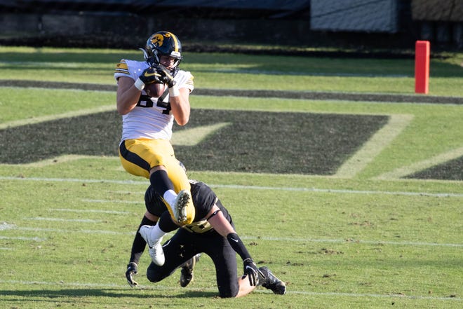 Oct 24, 2020; West Lafayette, Indiana, USA; Iowa Hawkeyes tight end Sam LaPorta (84) catches the ball while Purdue Boilermakers safety Brennan Thieneman (38) defends in the second quarter at Ross-Ade Stadium. Mandatory Credit: Trevor Ruszkowski-USA TODAY Sports