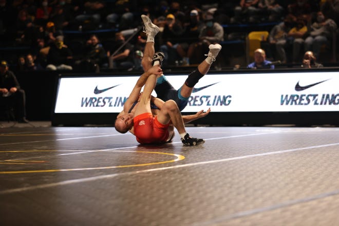 Carter Happel, blue, scores a takedown against Justin Stickley during the Hawkeye Wrestling Club Showdown Open on Sunday, Nov. 1, 2020, in Xtream Arena & GreenState Family Fieldhouse in Coralville, Iowa.