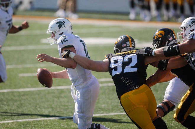 Iowa right end John Waggoner hits fellow West Des Moines' now Michigan State quarterback Rocky Lombardi during a play in the second quarter at Kinnick Stadium in Iowa City on Saturday, Nov. 7, 2020.