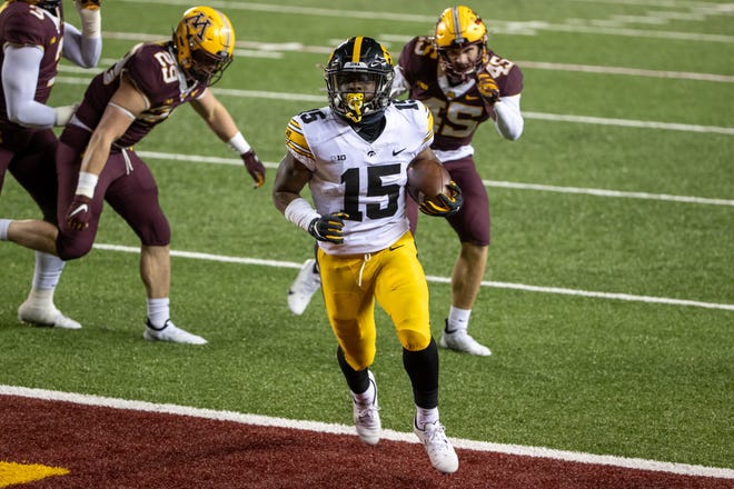 Nov 13, 2020; Minneapolis, Minnesota, USA; Iowa Hawkeyes running back Tyler Goodson (15) rushes for a touchdown in the second half against the Minnesota Golden Gophers at TCF Bank Stadium. Mandatory Credit: Jesse Johnson-USA TODAY Sports